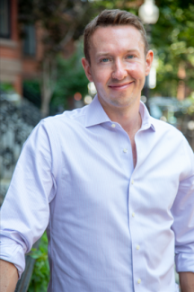 Headshot of James Uden, a white man with short hair in a button up shirt