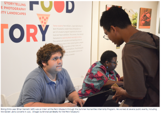 Ethan Nemeth, a white man in a blue polo shirt interacting with a patron at a museum event