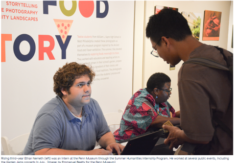 Ethan Nemeth, a white man in a blue polo shirt interacting with a patron at a museum event