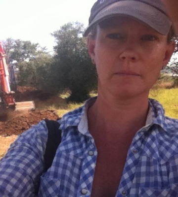  Head shot of Kim Bowes, a white woman in a hat and blue button up shirt